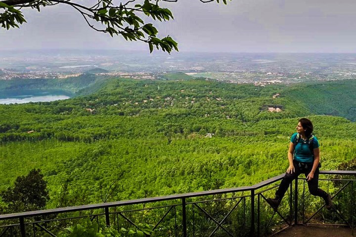 a person standing next to a fence overlooking a body of water