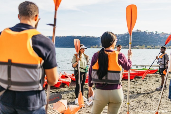 a group of people standing on a beach